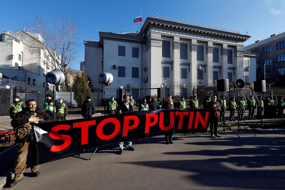 PHOTO: Ukrainians shout slogans, wave Ukrainian national and EU flags, hold banners as they protest outside Russian embassy in central Kyiv, Ukraine, Feb. 22, 2022.