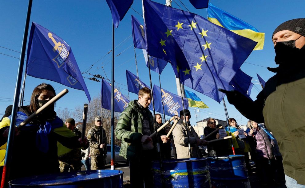 PHOTO: Ukrainians shout slogans, wave Ukrainian national and EU flags, hold banners as they protest outside Russian embassy in central Kyiv, Ukraine, Feb. 22, 2022.