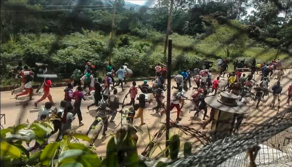 PHOTO: This frame grab taken from video footage shows crowds fleeing with items after they stormed a United Nations compound on the outskirts of the eastern town of Beni, Democratic Republic of Congo, Nov. 25, 2019.