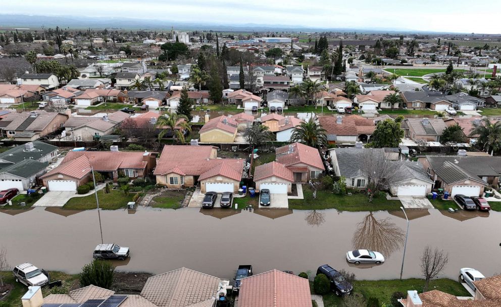 PHOTO: In an aerial view, homes are seen surrounded by floodwaters on Jan. 11, 2023 in Planada, Calif.