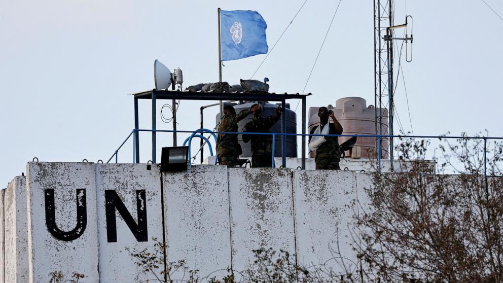 PHOTO: Members of the United Nations peacekeepers (UNIFIL) look at the Lebanese-Israeli border, as they stand on the roof of a watch tower in the town of Marwahin, in southern Lebanon, Oct. 12, 2023. 