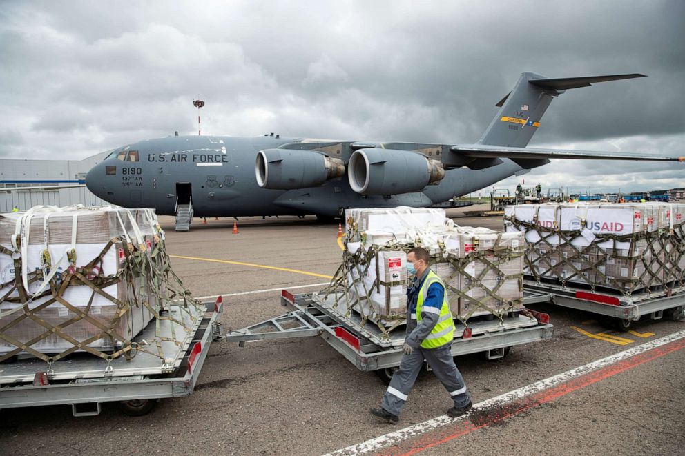 PHOTO: An airport worker walks past the batch of medical aid from the United States at Vnukovo International Airport outside Moscow, Russia, on June 4, 2020.