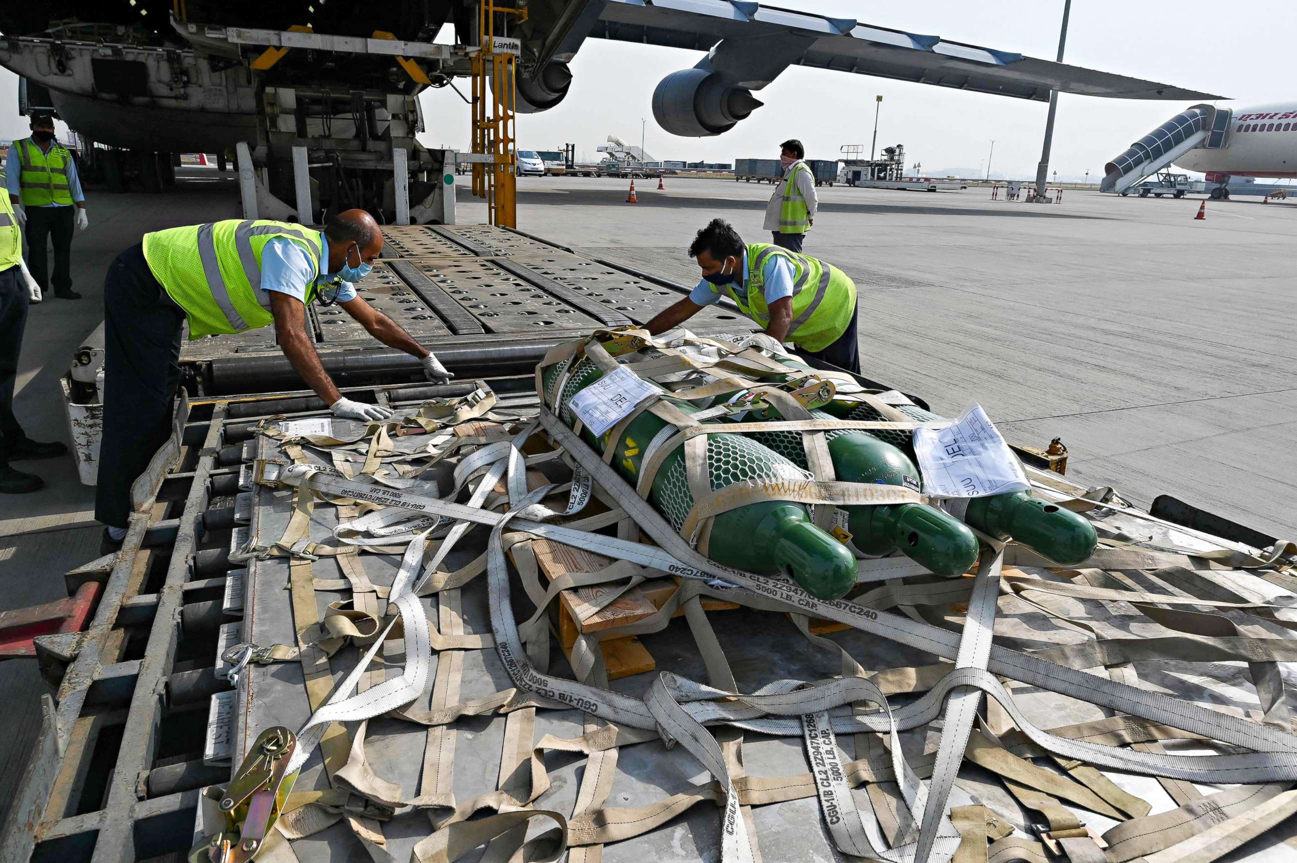 PHOTO: Ground staff unload COVID-19 relief supplies from the U.S. at the Indira Gandhi International Airport cargo terminal in New Delhi on April 30, 2021.