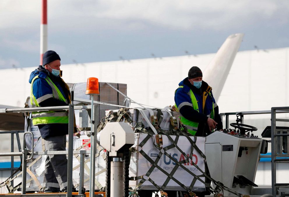 PHOTO: Workers unload a U.S. Air Force C-17 Globemaster transport plane which delivered the first batch of medical aid from the United States at Vnukovo International Airport in Moscow on May 21, 2020, amid the coronavirus pandemic.