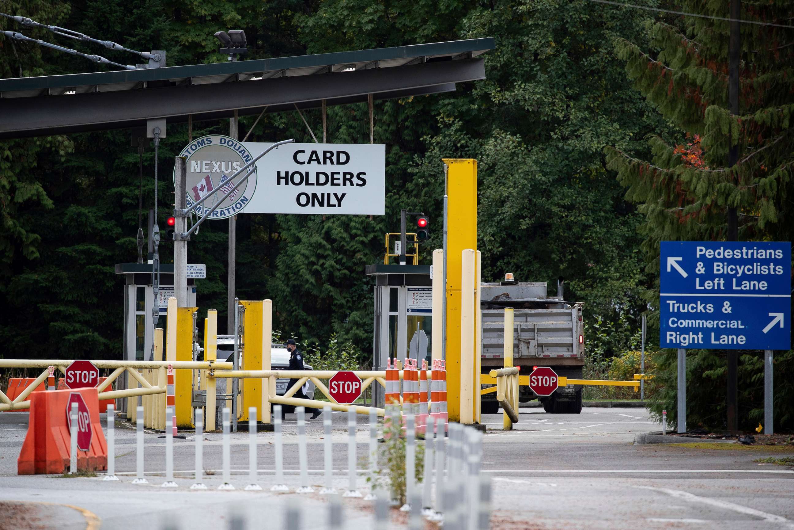 PHOTO: A U.S. Customs and Border Protection officer working at the Point Roberts-Boundary Bay border crossing, in Point Roberts, Wash., is seen from Delta, British Columbia on Oct. 13, 2021.