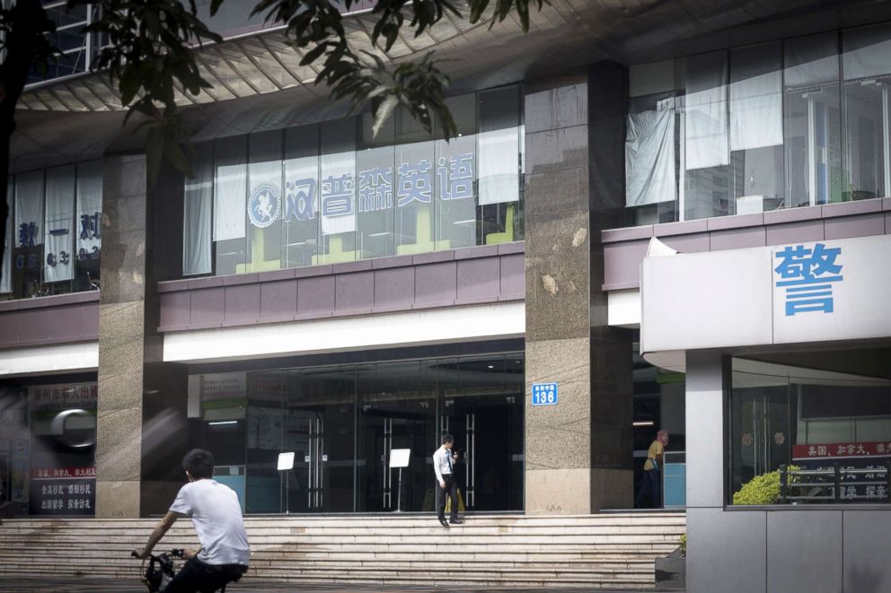 PHOTO: A cyclist rides past the Tianyu Garden building where the US consulate in Guangzhou is located in Guangzhou city, south Chinas Guangdong province, May 16, 2013.