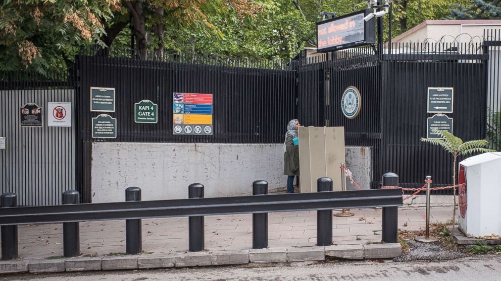 A woman stands at the closed entrance of the United States Embassy in Ankara, Turkey, Oct. 9, 2017. American visa services were halted at US missions in Turkey following the detention of US consulate personnel in Istanbul, a move that sparked a diplomatic backlash between both countries.