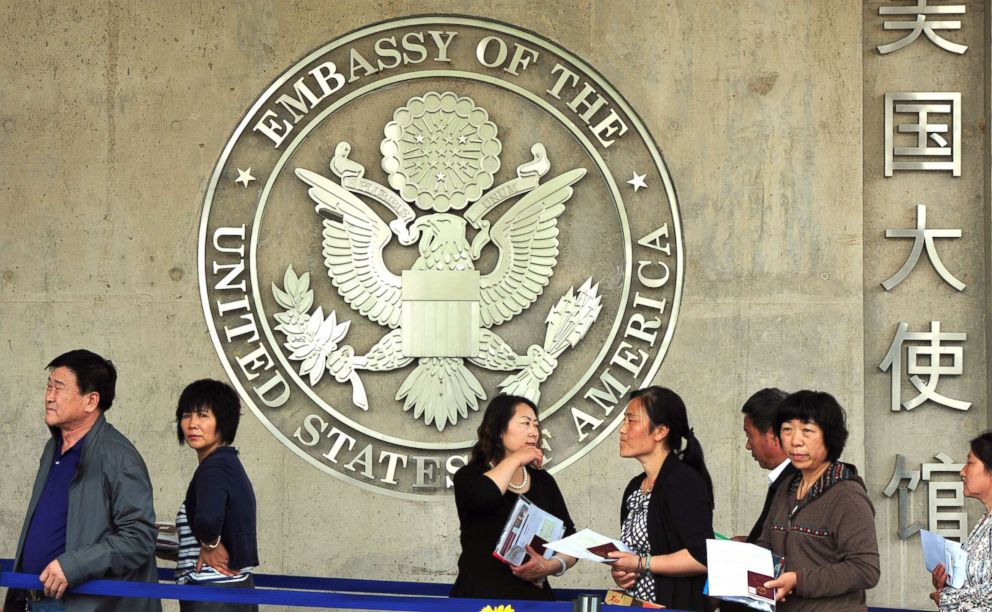 PHOTO: Chinese citizens wait to submit their visa applications at the US Embassy where blind rights activist Chen Guangcheng is believed to be hiding, in Beijing on May 2, 2012. 