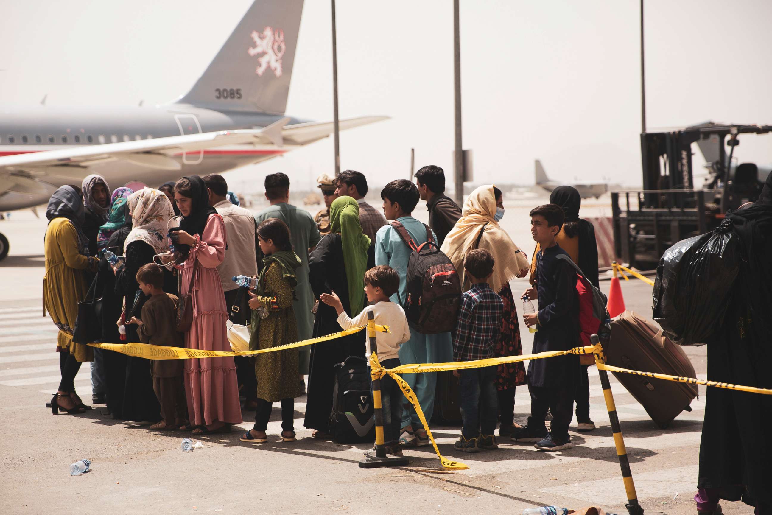PHOTO: Civilians prepare to board a plane during an evacuation at Hamid Karzai International Airport in Kabul, Aug. 18, 2021.