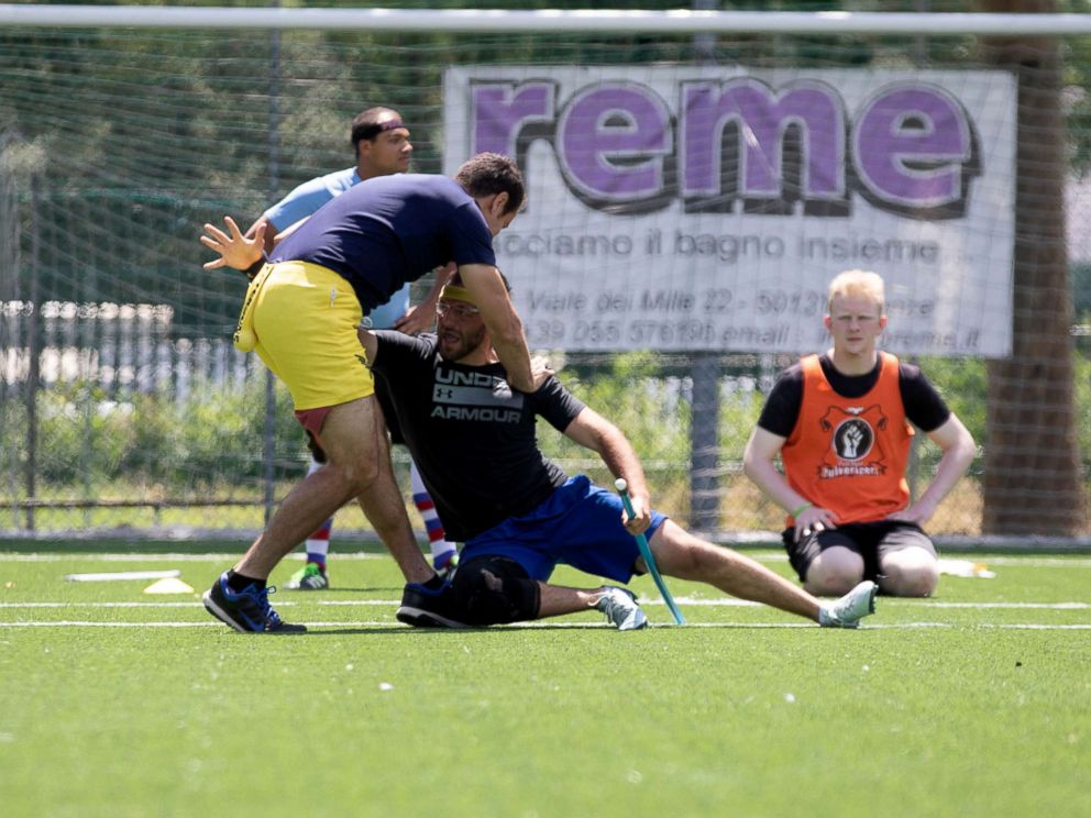 PHOTO: US Quidditch team coach Michael Yada Parada, left, is seen as the snitch alongside seeker Harry Greenhouse during practice in Florence, Italy, June 26, 2018.