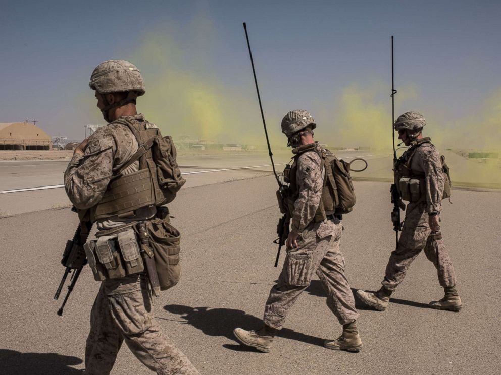 PHOTO: Members of the U.S. Marine Corp Task Force South West walk across a runway after marking a location for an airdrop of cargo on Sept. 10, 2017 at Camp Shorab in Helmand Province, Afghanistan.