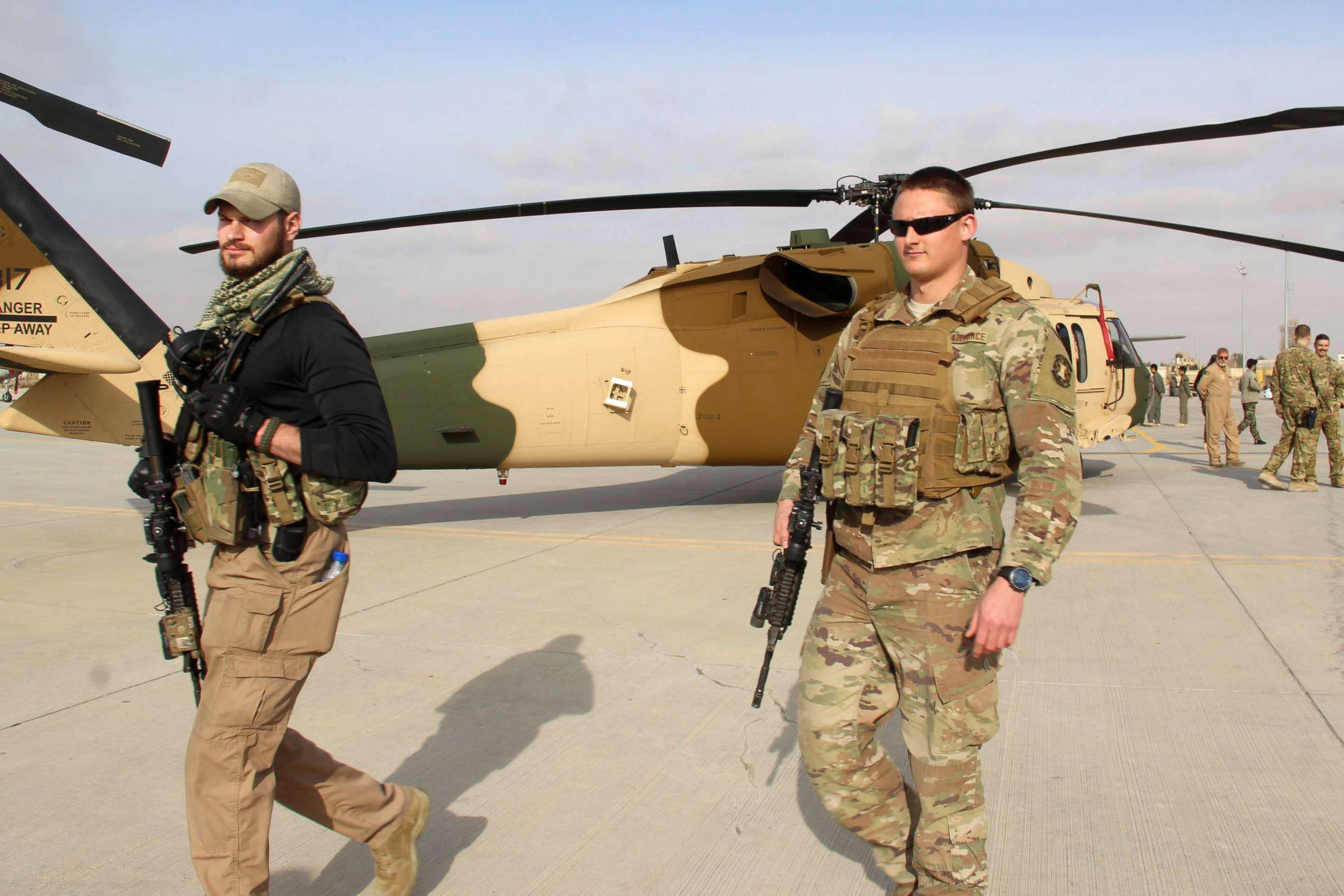 PHOTO: U.S. soldiers walk near a Black Hawk helicopter, one of four delivered by the U.S. to Afghan military, in Kandahar, Afghanistan, Jan. 23, 2018.