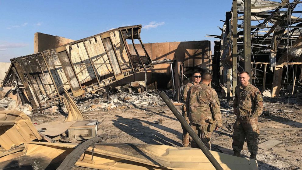 PHOTO: U.S. soldiers stand at the site where an Iranian missile hit at Ain al-Asad air base in Anbar province, Iraq, Jan. 13, 2020. 