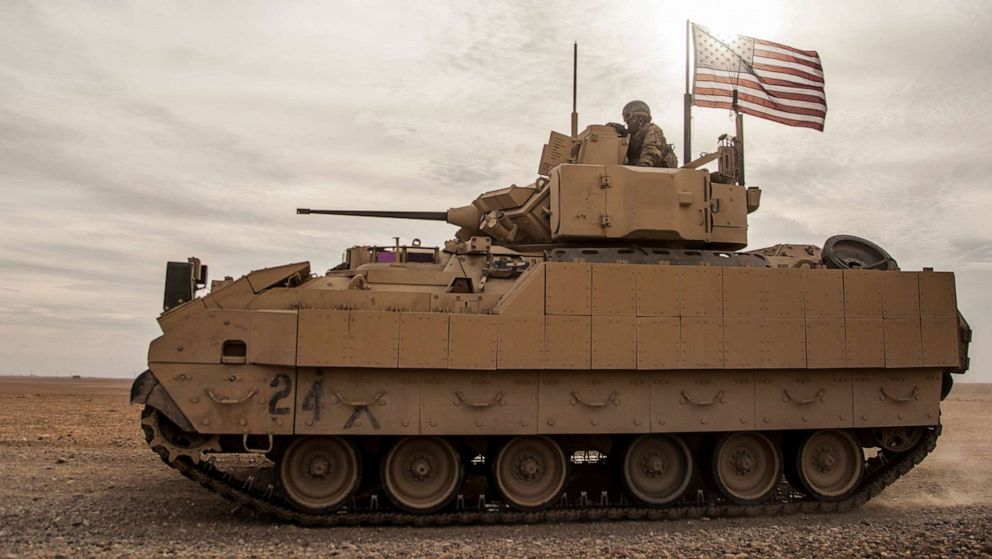 PHOTO: In this Dec. 8, 2021, file photo, American soldiers drive a Bradley fighting vehicle during a joint exercise with Syrian Democratic Forces at the countryside of Deir Ezzor in northeastern Syria.