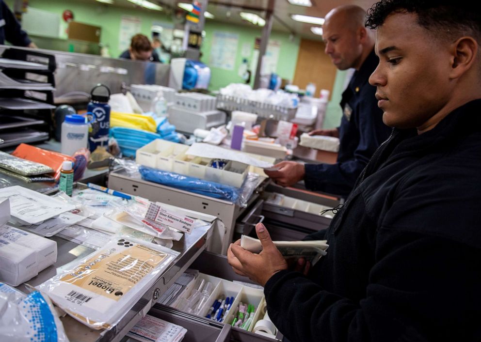 PHOTO: Hospitalman Jeremiah Lewis organizes medical supplies aboard the Military Sealift Command hospital ship USNS Mercy off the coast of southern California, March 24, 2020.