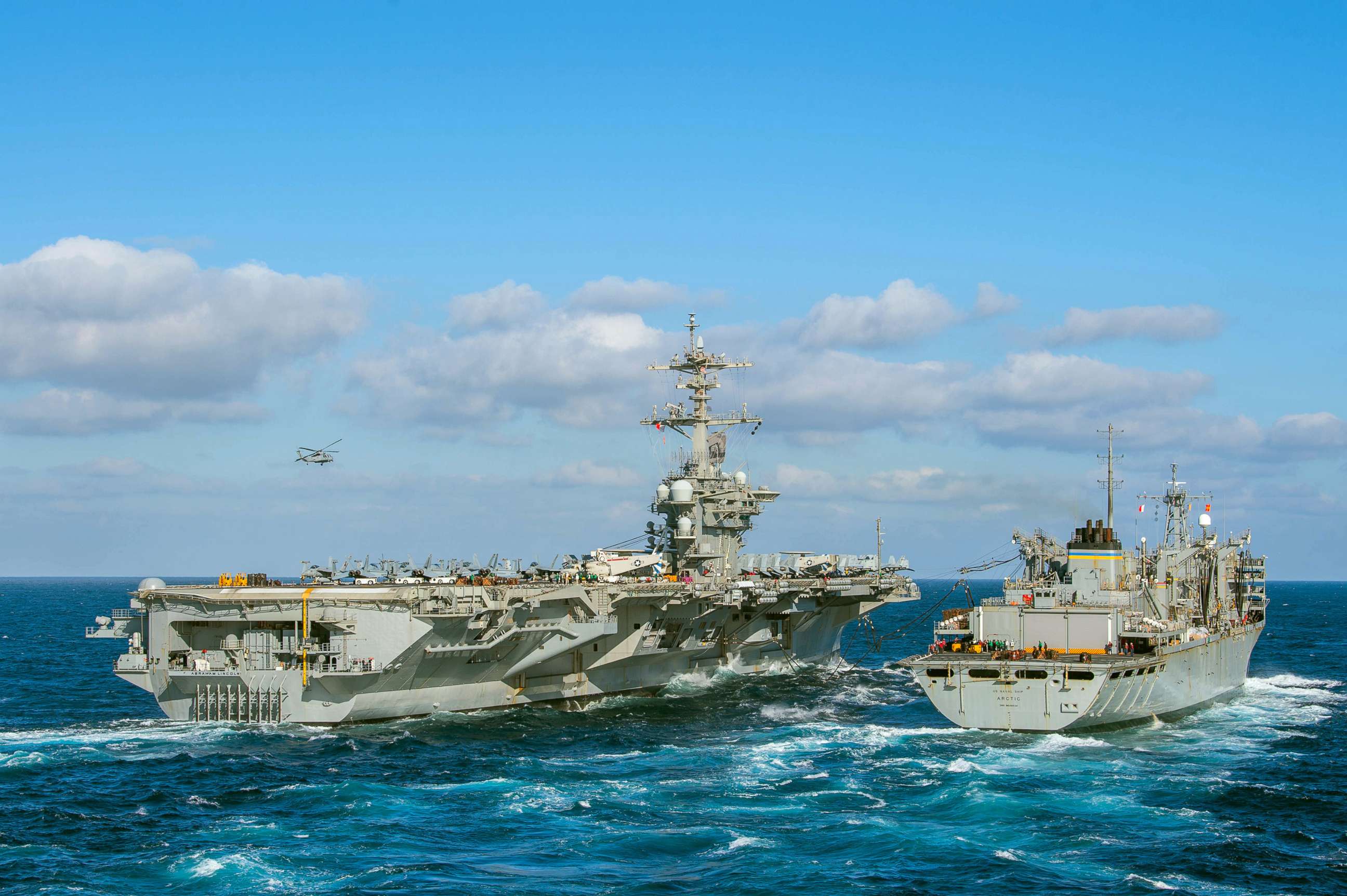 PHOTO: The Nimitz-class aircraft carrier USS Abraham Lincoln conducts a replenishment-at-sea  with the fast combat support ship USNS Arctic, April 12, 2019 in the Atlantic ocean.