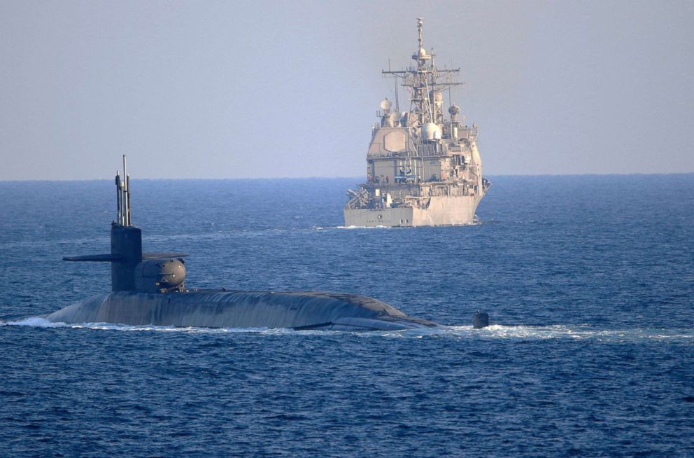 PHOTO: In this photo made available by the U.S. Navy, the guided-missile submarine USS Georgia, front, with the guided-missile cruiser USS Port Royal, transit the Strait of Hormuz in Persian Gulf, Monday, Dec. 21, 2020.