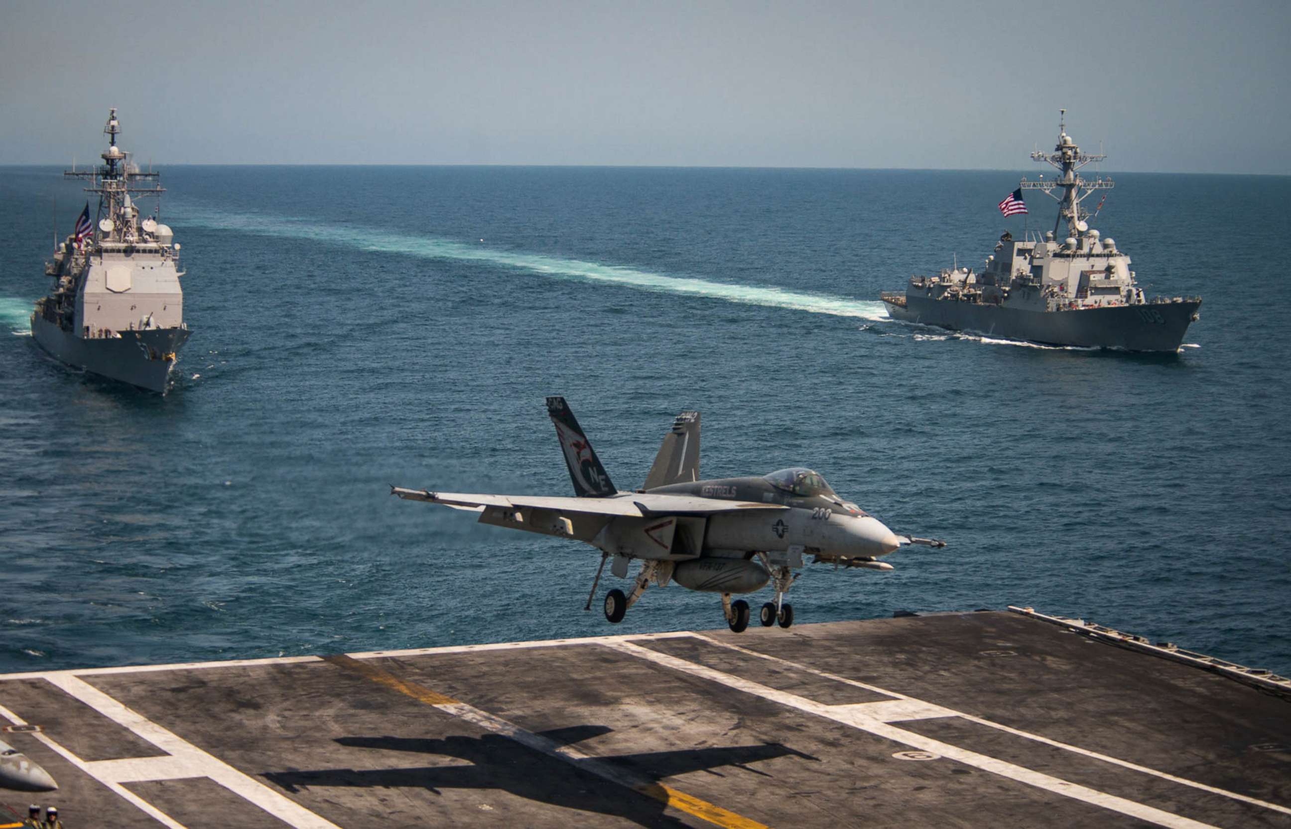 PHOTO: An F/A-18E Super Hornet lands on the flight deck of the USS Carl Vinson and the USS Lake Champlain (CG 57) (L) and the Arleigh Burke-class guided-missile destroyer USS Wayne E. Meyer (DDG 108), May 3, 2017, in the western Pacific Ocean. 