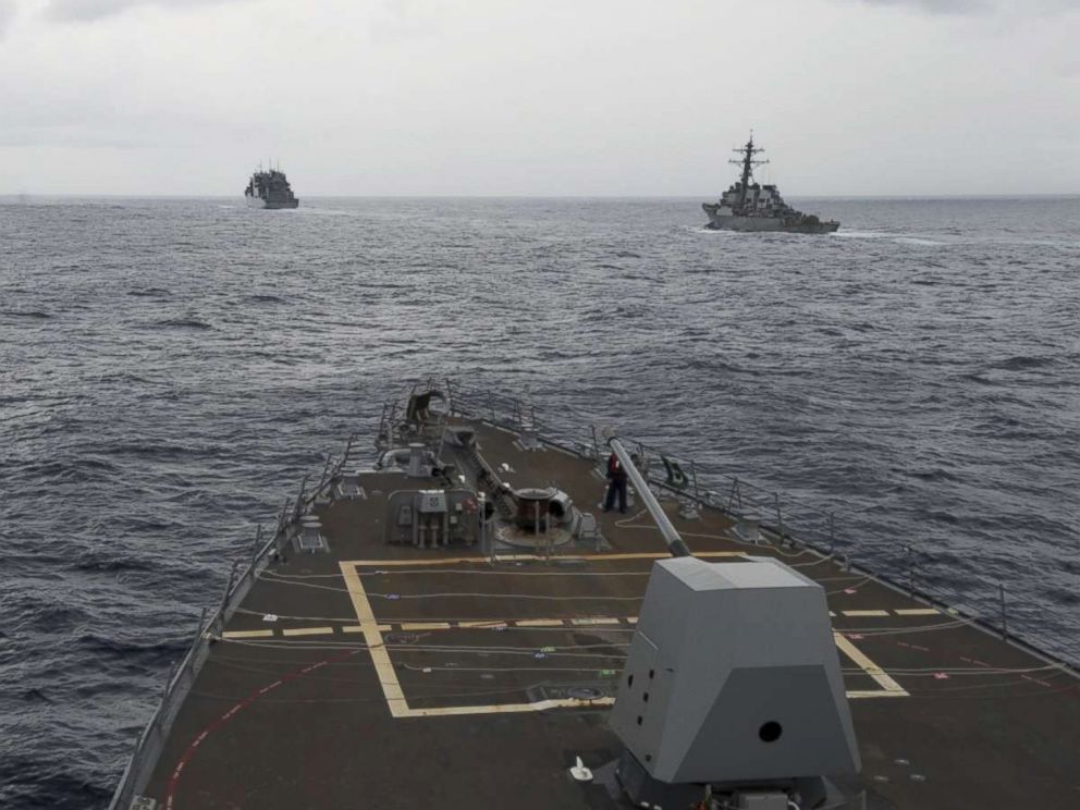 PHOTO: This image provided by the U.S. Navy, taken Oct. 17, 2016, shows the guided missile destroyer USS Decatur, right, pulling into position behind the Military Sealift Command USNS Matthew Perry, seen from the the USS Spruance, in the South China Sea.