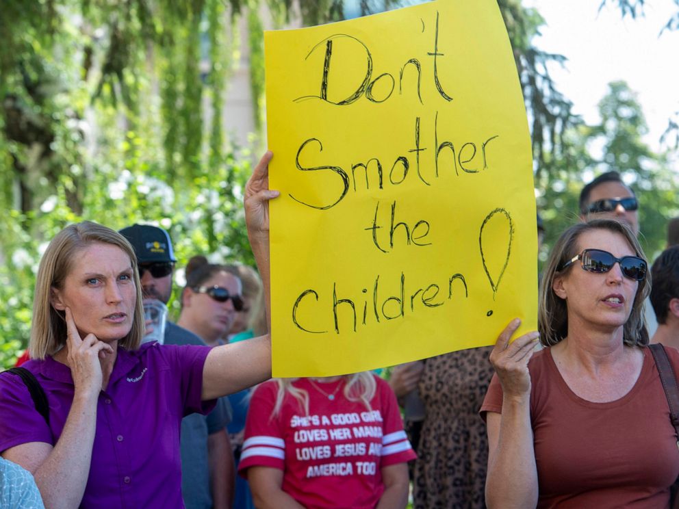 PHOTO: Protesters listen as commissioner Bill Lee speaks during a rally protesting face masks being required in schools, before the Utah County Commission meeting in Provo, Utah, July 15, 2020.