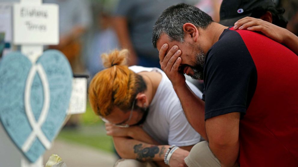 PHOTO: Vincent Salazar, right, weeps in front of a cross for his daughter Layla Salazar at a memorial site for the victims killed at Robb Elementary School in Uvalde, Texas, May 27, 2022.
