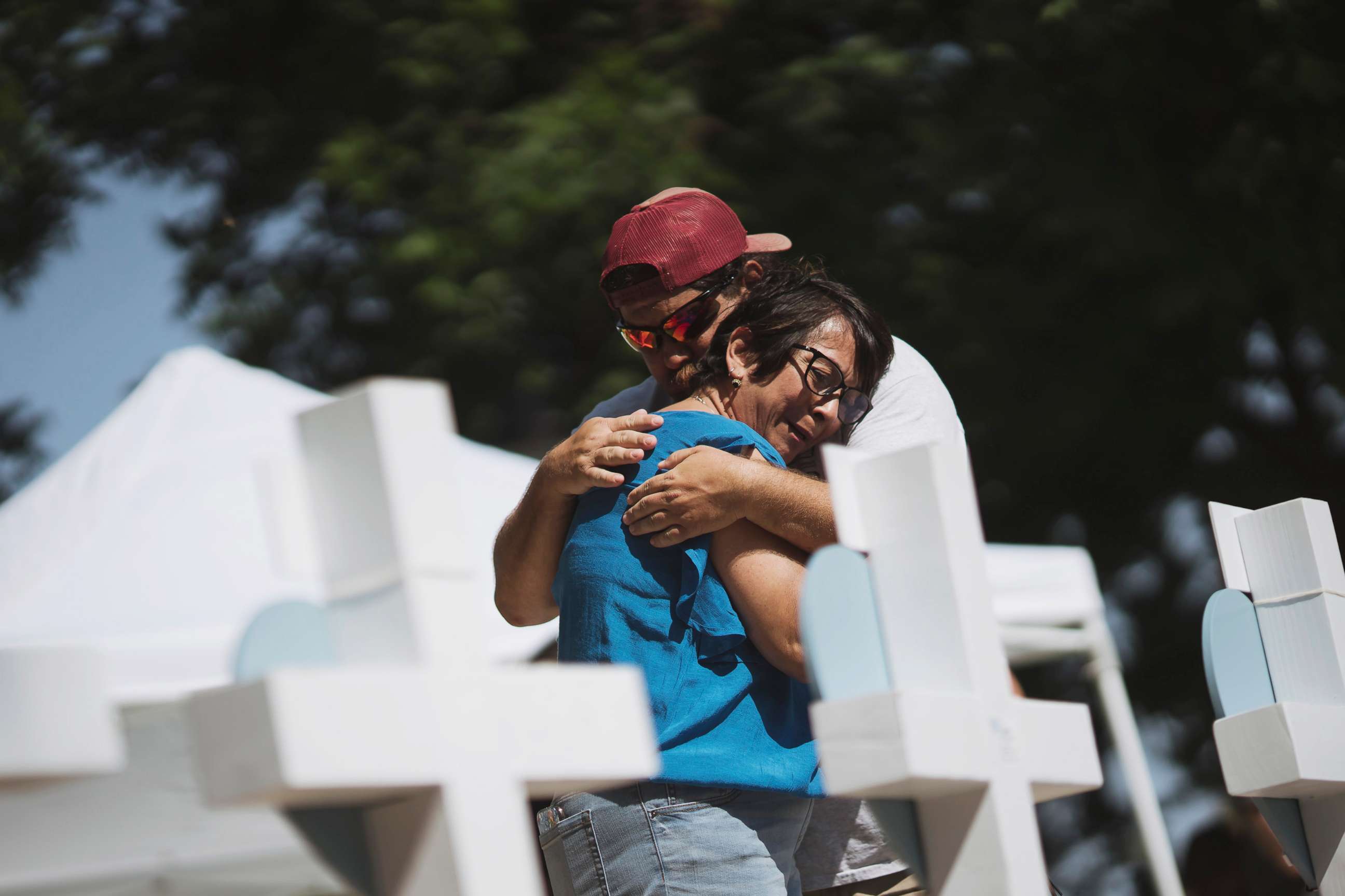 PHOTO: People embrace at a memorial in the town square for victims of Tuesday's mass shooting at Robb Elementary School on May 26, 2022 in Uvalde, Texas.