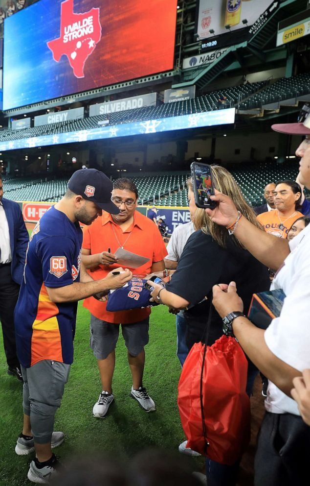 PHOTO: Jose Altuve of the Astros signs autographs at the Uvalde Strong Day game against the Oakland Athletics in Houston, Aug. 14, 2022.