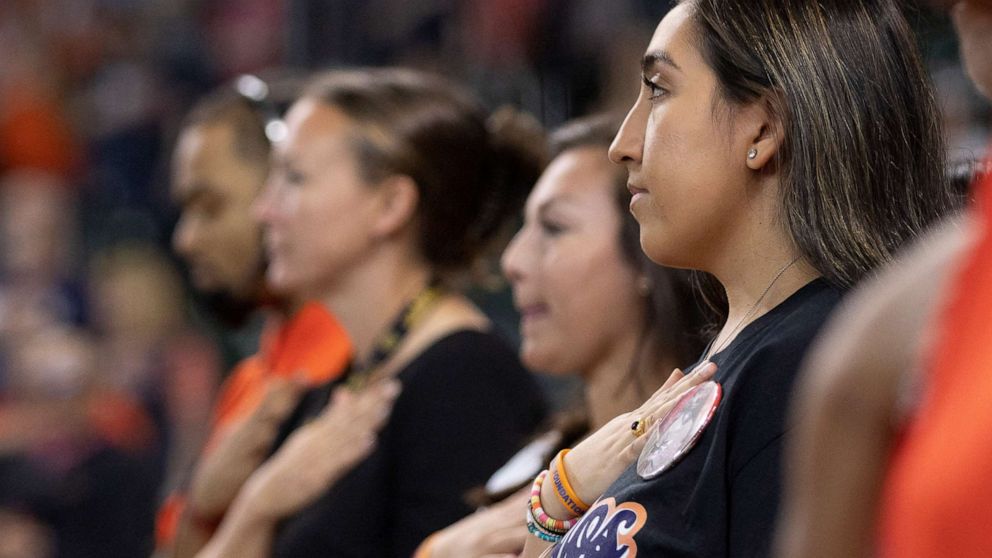 PHOTO: Uvalde resident Faith Mata takes a moment of silence for the Uvalde children that were killed in the mass shooting before the Astros versus Athletics game in Houston, Aug. 14, 2022.