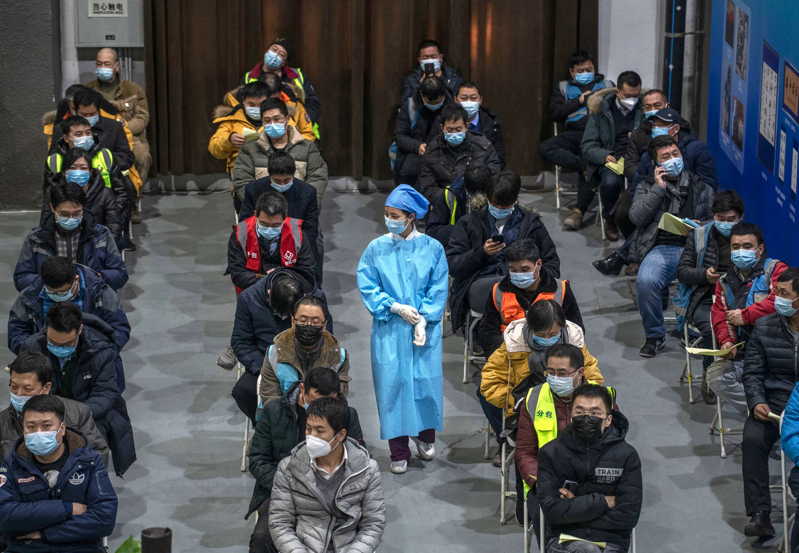 PHOTO: Chinese workers, including security guards, wait to receive a COVID-19 vaccine jab at a mass vaccination center for Chaoyang District on Jan. 15, 2021, in Beijing.