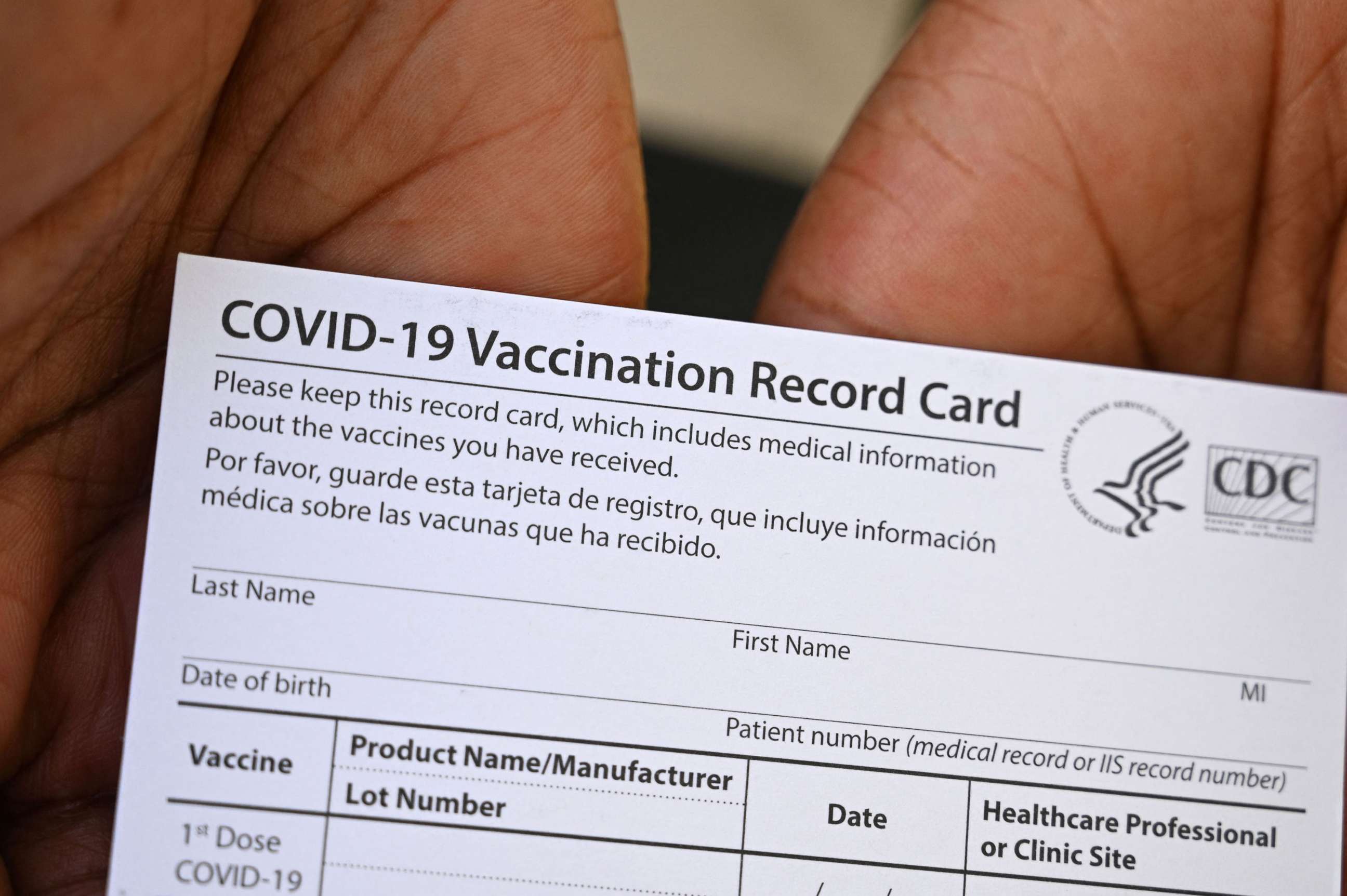 PHOTO: A healthcare worker displays a Covid-19 Vaccination Record Card during a vaccine and health clinic in Los Angeles, Aug. 11, 2021.