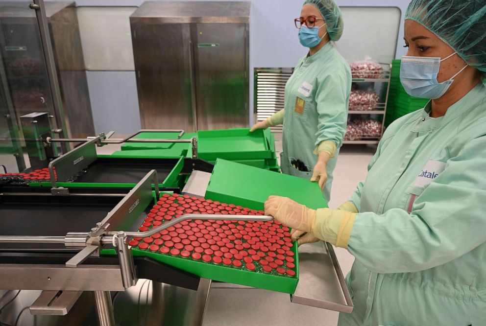 PHOTO: Lab technicians handle capped vials as part of filling and packaging tests for the large-scale production and supply of the University of Oxfords COVID-19 vaccine candidate, AZD1222, on Sept. 11, 2020, at a manufacturing facility in Anagni, Italy.