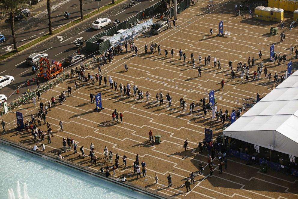 PHOTO: People queue outside a Covid-19 mass vaccination center at Rabin Square in this aerial photograph taken in Tel Aviv, Israel, Jan. 4, 2020.  