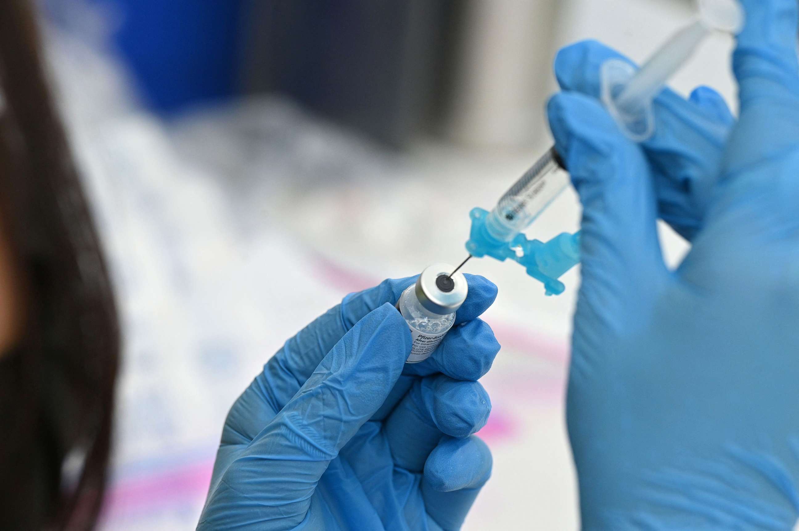 PHOTO: A healthcare worker fills a syringe with Pfizer COVID-19 vaccine at a community vaccination event in Los Angeles, Aug. 11, 2021.