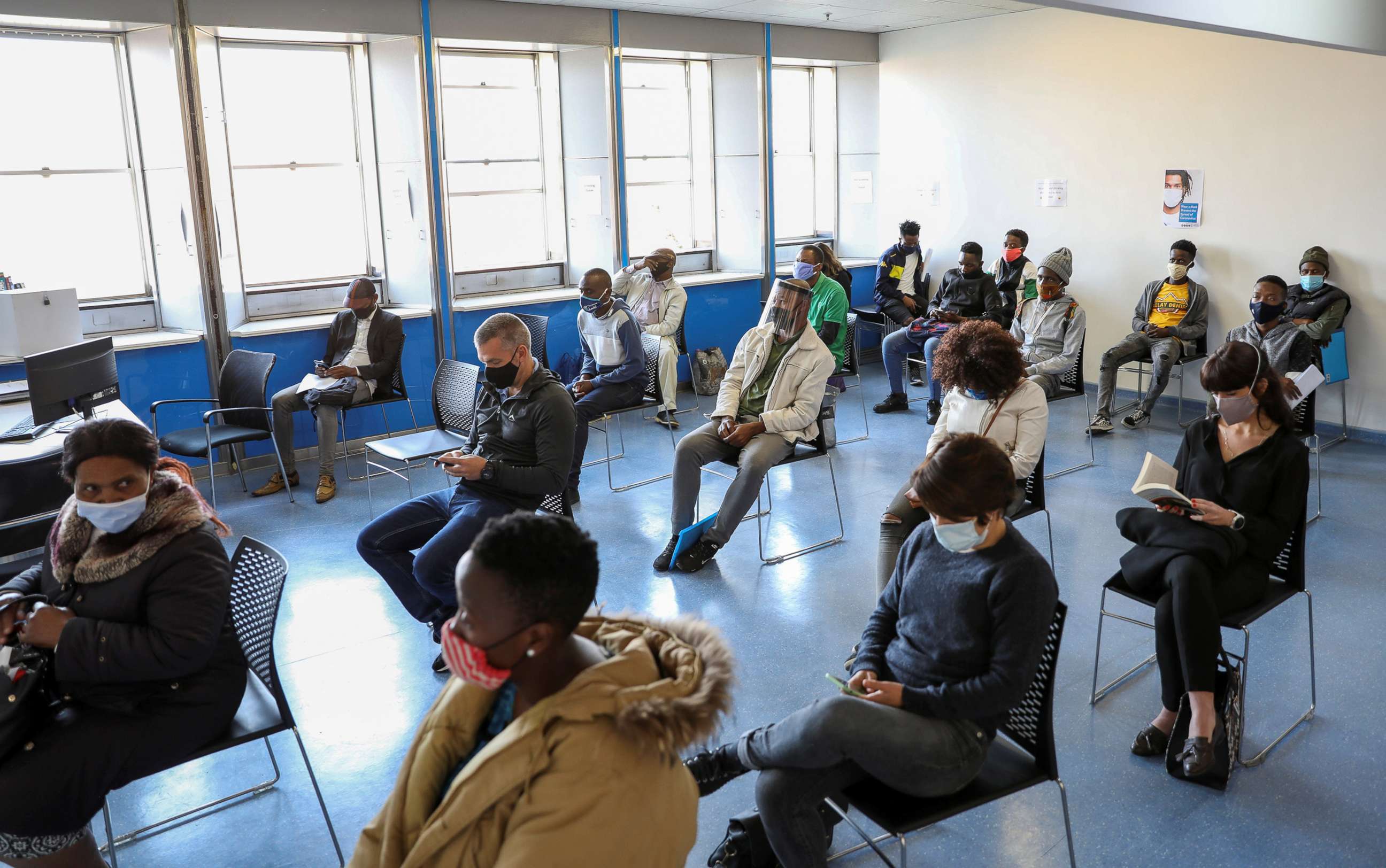 PHOTO: Vaccine trial volunteers wait for their names to be called before being tested for the coronavirus disease and taking part in the country's human clinical trial for a COVID-19 vaccine in Johannesburg, Aug. 27, 2020.