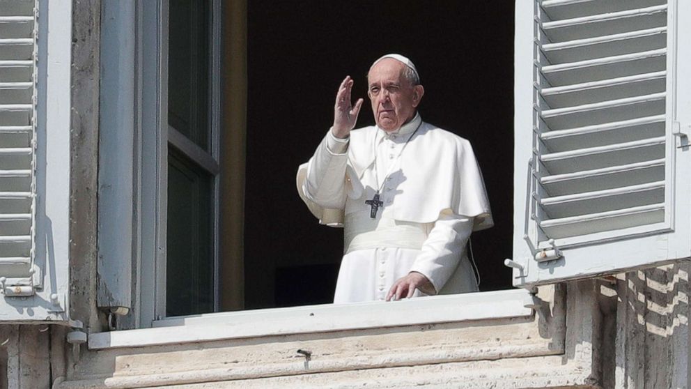 PHOTO: Pope Francis delivers his blessing from the window of his private library overlooking St. Peter's Square, at the Vatican, March 22, 2020.