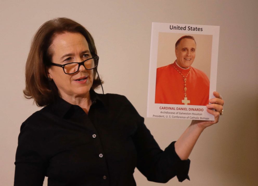 PHOTO: Anne Barrett Doyle, co-director of BishopAccountability.org group, holds up a photo of Cardinal Daniel DiNardo in Rome, Feb. 19, 2019. 