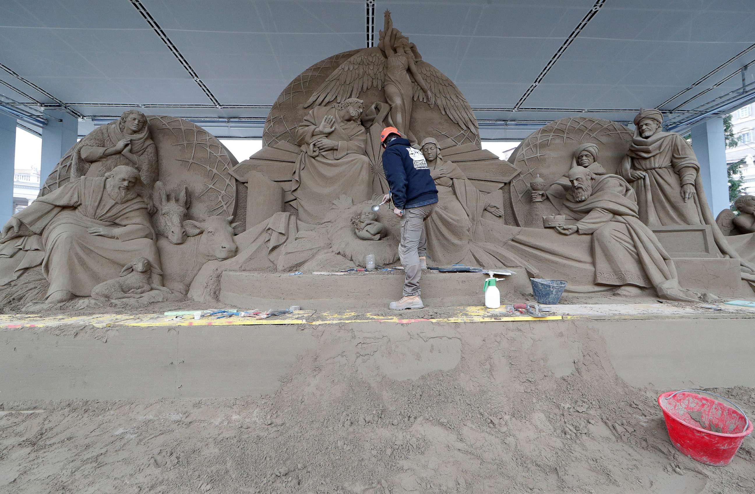 PHOTO: An artist works on a sand sculpture representing part of nativity scene in St. Peter's square at the Vatican, Dec. 6, 2018.