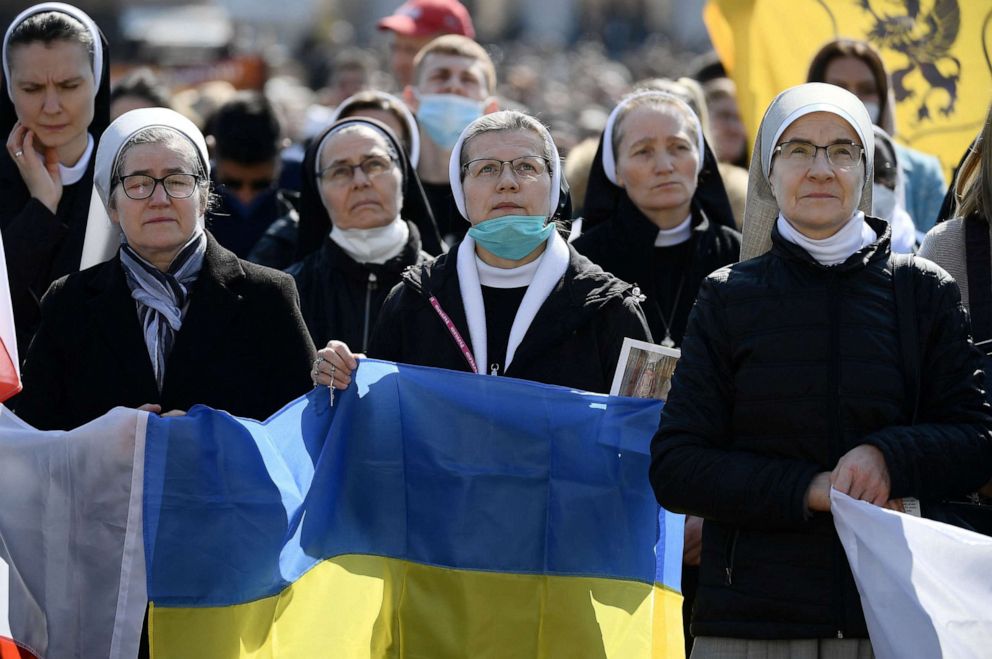 PHOTO: Nuns hold the Ukranian flag as Pope Francis delivers the Sunday Angelus prayer at the Vatican on March 6, 2022.