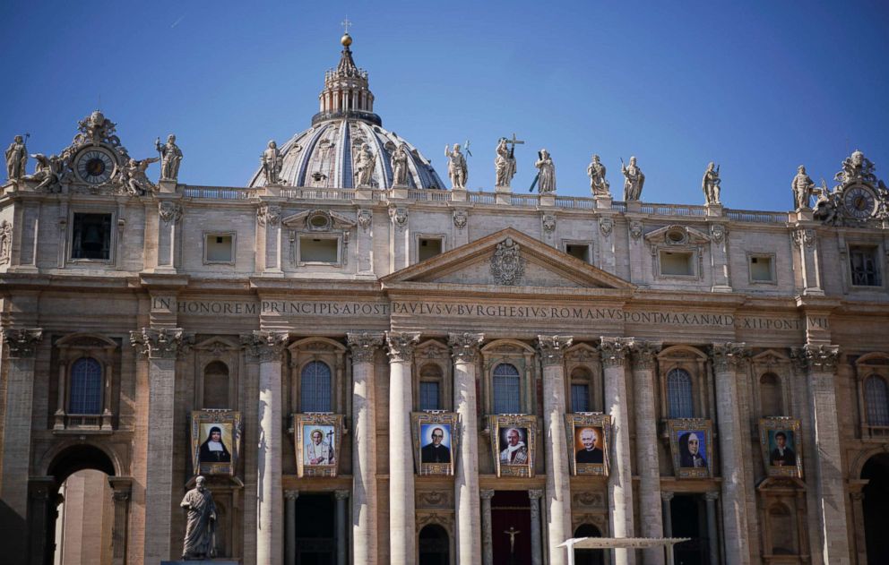 PHOTO: The tapestries of Roman Catholic Archbishop Oscar Romero, 3rd from left, and Pope Paul VI, 4th from left, hang from a balcony of the facade of St. Peter's Basilica at the Vatican, Oct. 13, 2018.