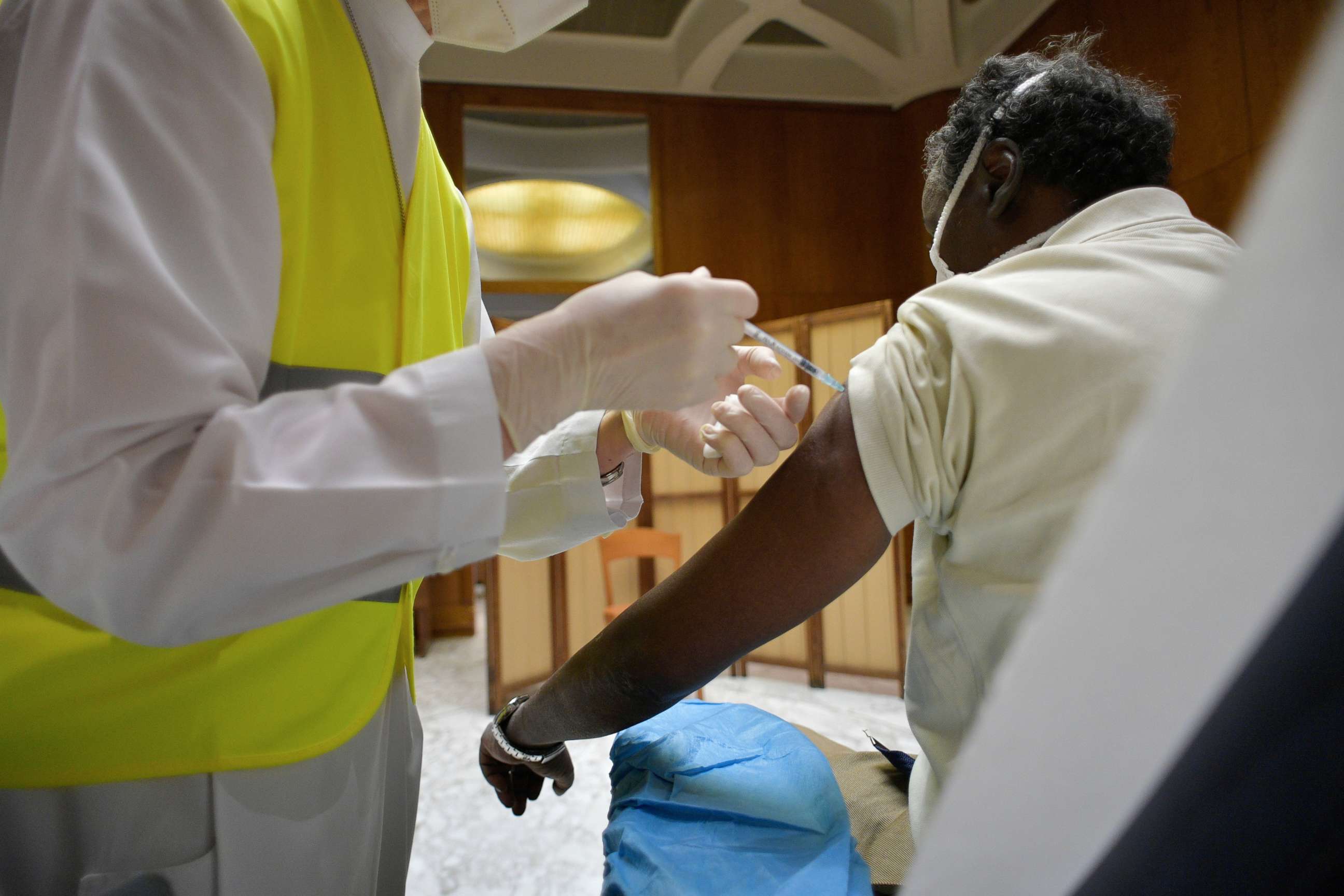 PHOTO: A person receives a dose of a vaccine against the coronavirus disease (COVID-19), at Paul VI Hall in the Vatican, March 31, 2021.