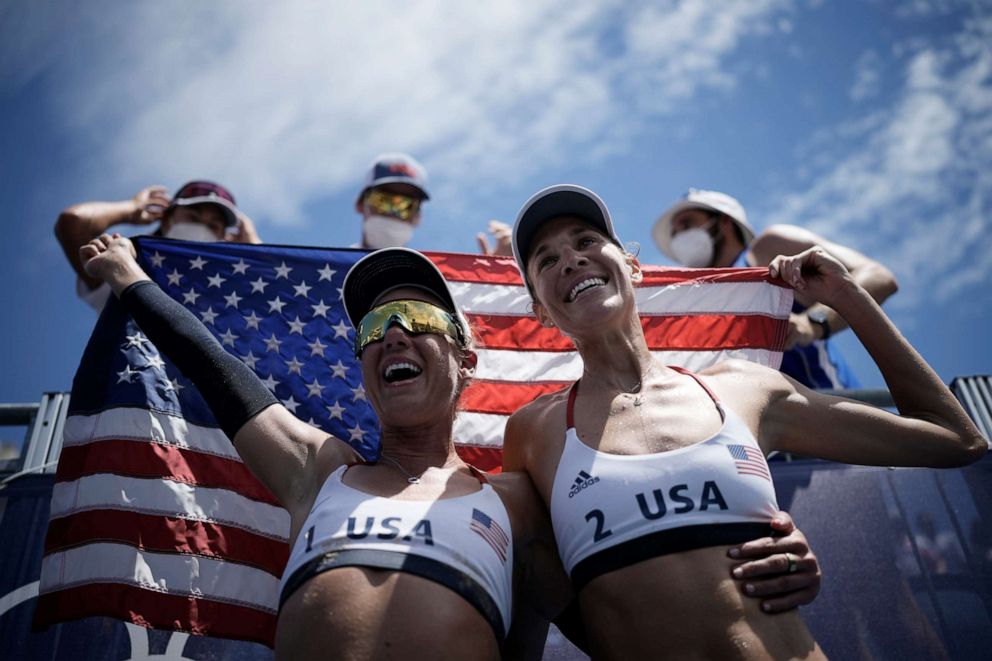 PHOTO: April Ross, left, of the United States, and teammate Alix Klineman celebrate winning a women's beach volleyball Gold Medal match against Australia at the 2020 Summer Olympics, Aug. 6, 2021, in Tokyo, Japan.