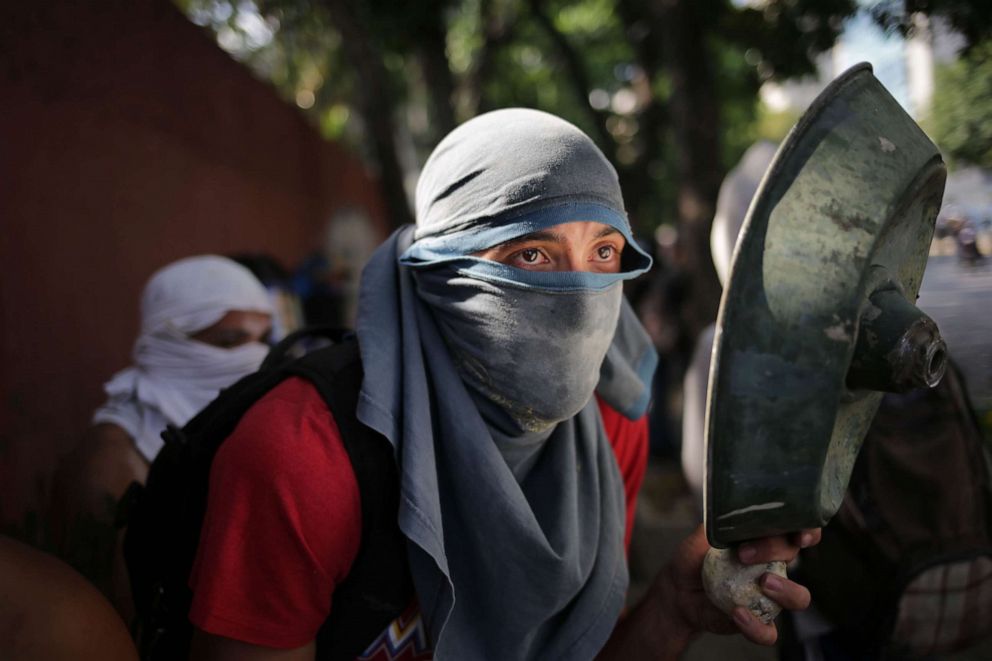 PHOTO: An opposition demonstrator clashes with soldiers loyal to Venezuelan President Nicolas Maduro after troops joined opposition leader Juan Guaido in his campaign to oust Maduro's government, in Caracas, April 30, 2019. 