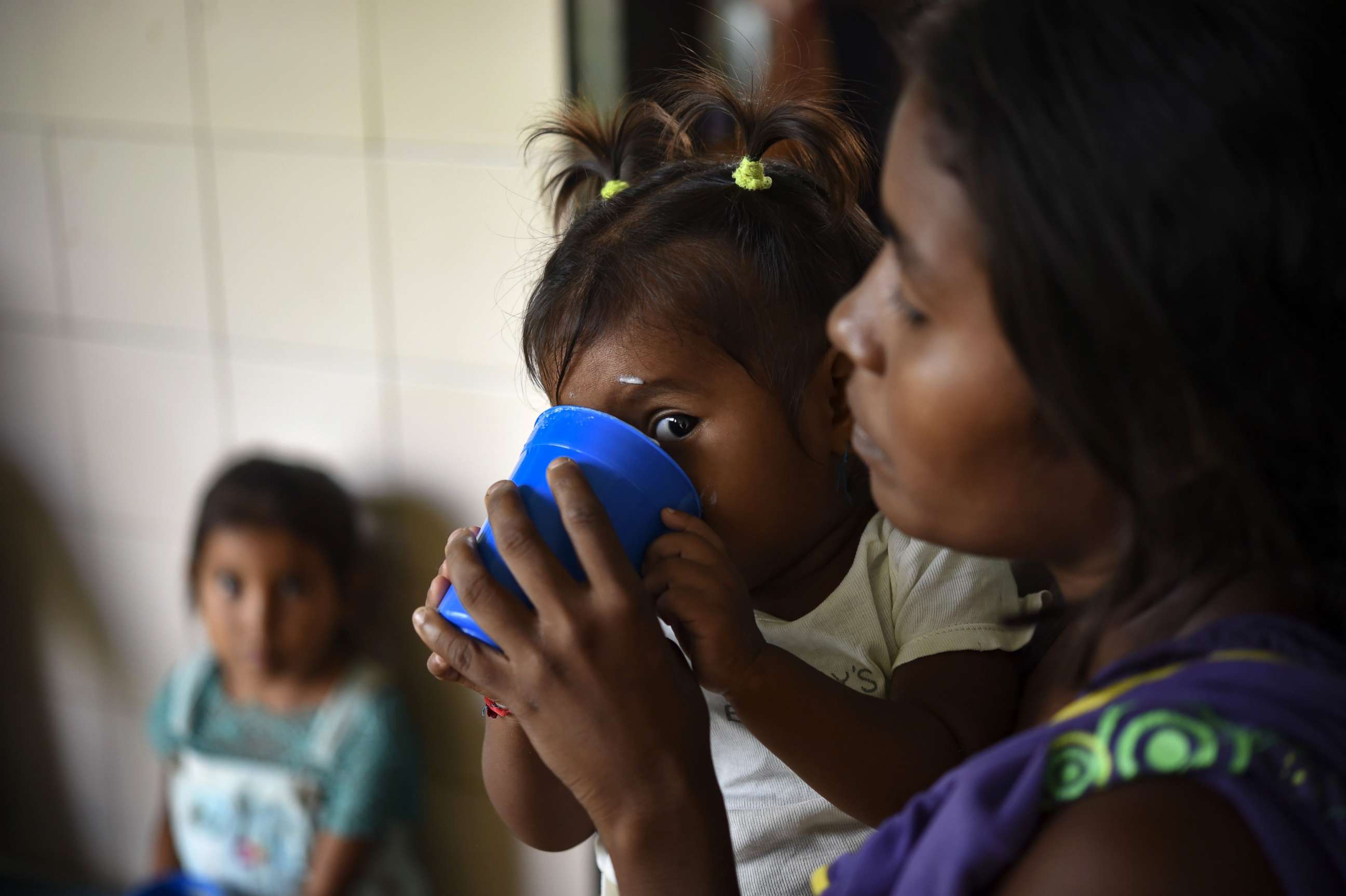 PHOTO: Yukpa indigenous children, some of them suffering from malnutrition, are fed with supplements provided by CARITAS organization, at Los Angeles del Tukuko mission, near Machiques, Zulia state, Venezuela, July 5, 2019. 