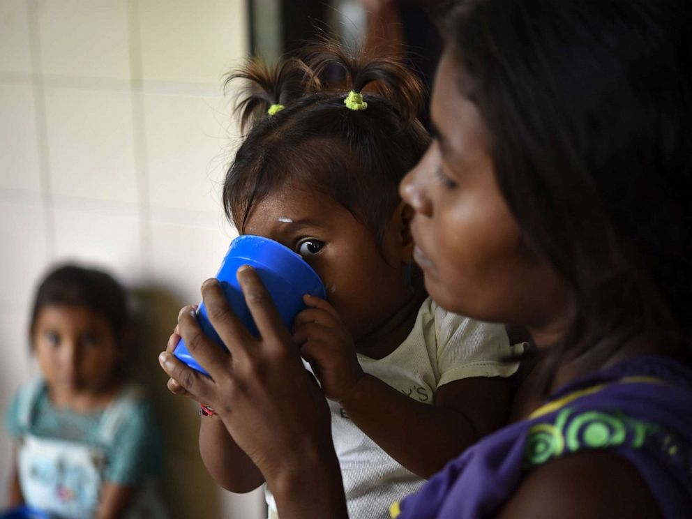 PHOTO: Yukpa indigenous children, some of them suffering from malnutrition, are fed with supplements provided by CARITAS organization, at Los Angeles del Tukuko mission, near Machiques, Zulia state, Venezuela, July 5, 2019.