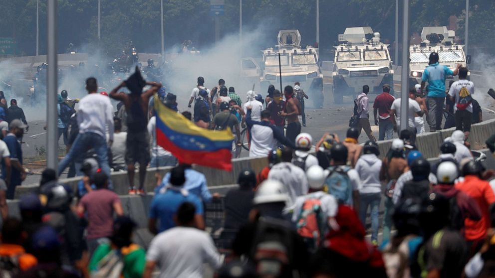 PHOTO: Opposition demonstrators face military vehicles near the Generalisimo Francisco de Miranda Airbase "La Carlota" in Caracas, Venezuela April 30, 2019.