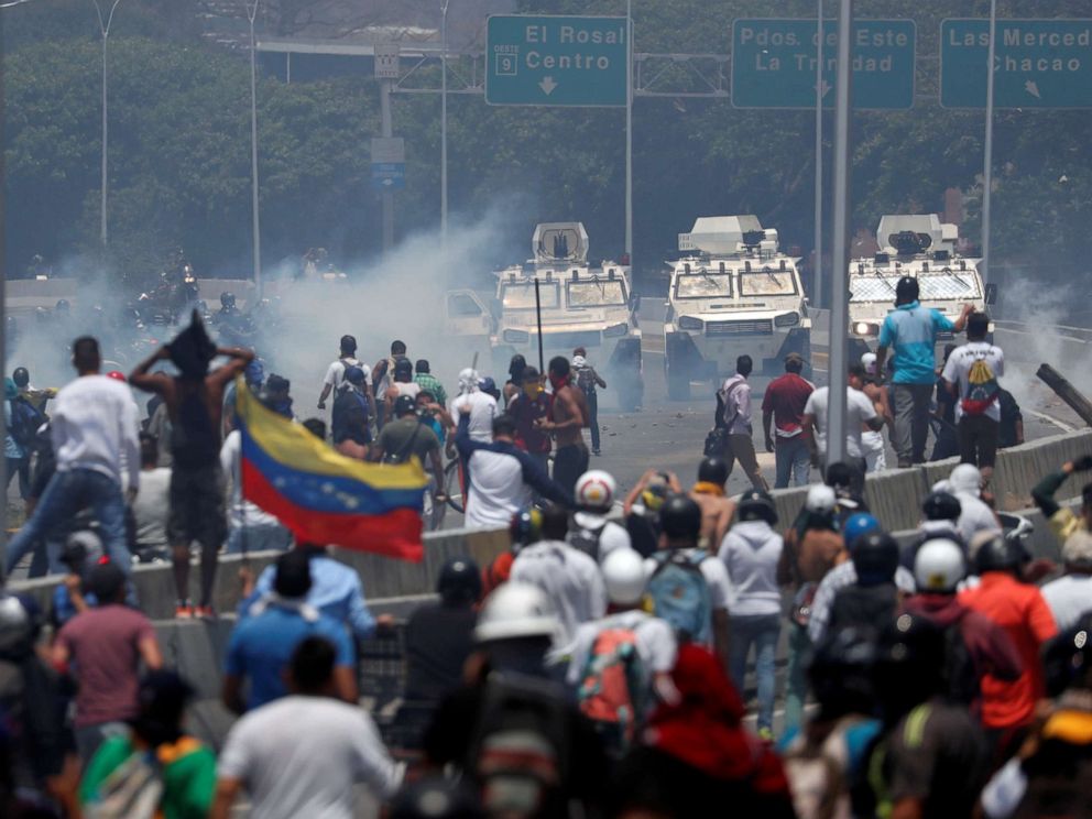 PHOTO: Opposition protesters face military vehicles near Generalisimo Francisco de Miranda La Carlota Air Base in Caracas (Venezuela) on April 30, 2019.