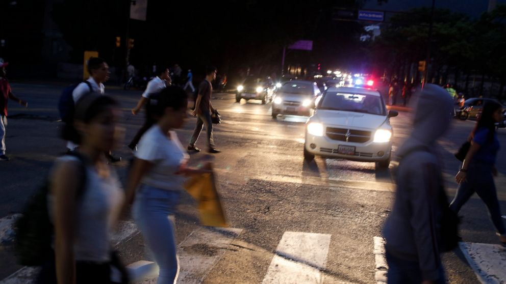 PHOTO: People cross a street during a blackout in Caracas, Venezuela, Monday, July 22, 2019.
