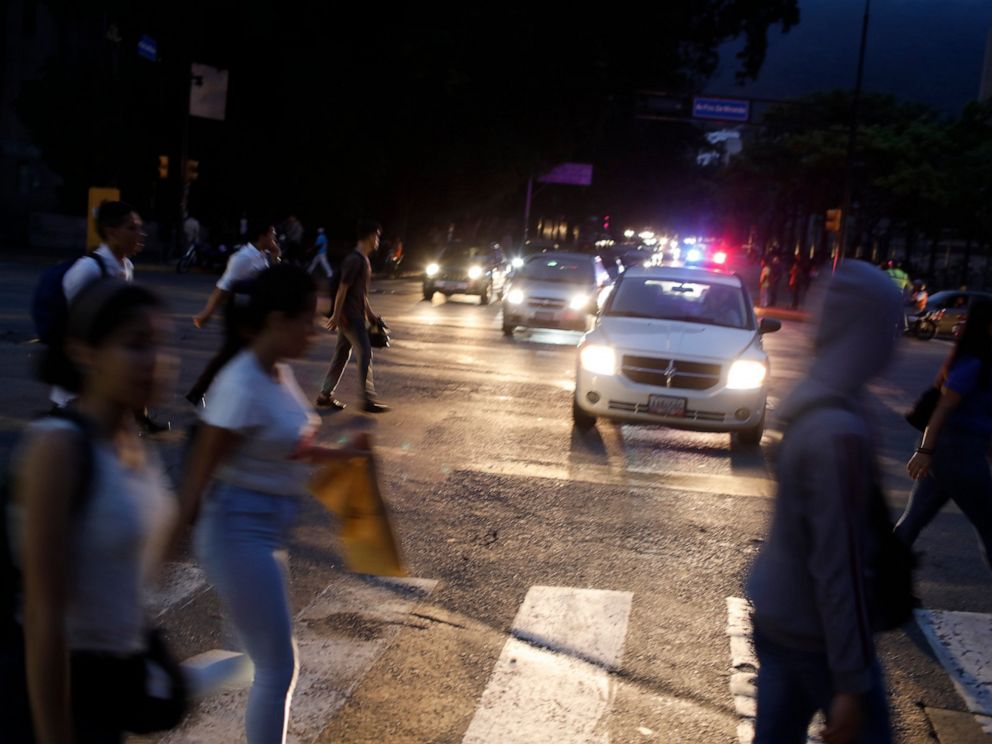 PHOTO: People cross a street during a blackout in Caracas, Venezuela, Monday, July 22, 2019.
