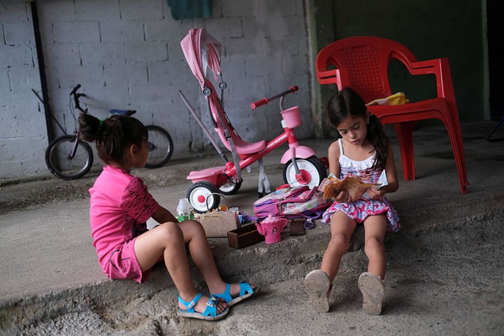 PHOTO: Deina Alvarez, 6, who is undergoing treatment for malnutrition, plays with Venezuelan bolivar notes that have been made worthless by hyperinflation, at her house in Barquisimeto, Venezuela, Nov. 27, 2019.