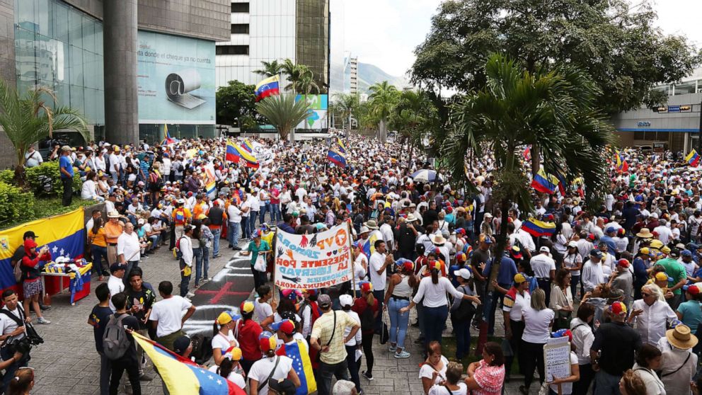 PHOTO: Venezuelans wave flags and hold signs as people gather at PNUD for a demonstration called by opposition leader Juan Guaido during the 208th anniversary of the Venezuelan Independence declaration on July 5, 2019, in Caracas, Venezuela.